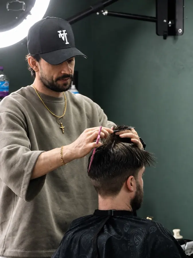 Mikey cutting hair at Rhythm & Roots
